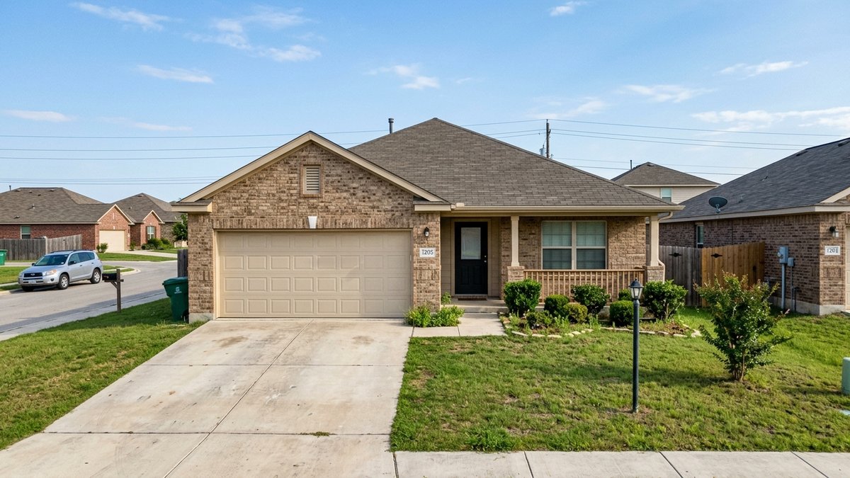 Mid-priced single-story brick tract home in a New Braunfels subdivision, simple front lawn, casual daylight.